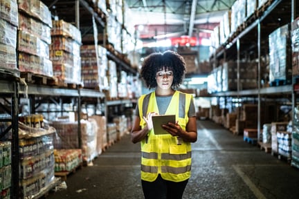 Person in high-visibility jacket in the warehouse