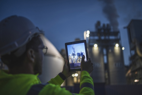 An assessor capturing a photograph of a nuclear plant